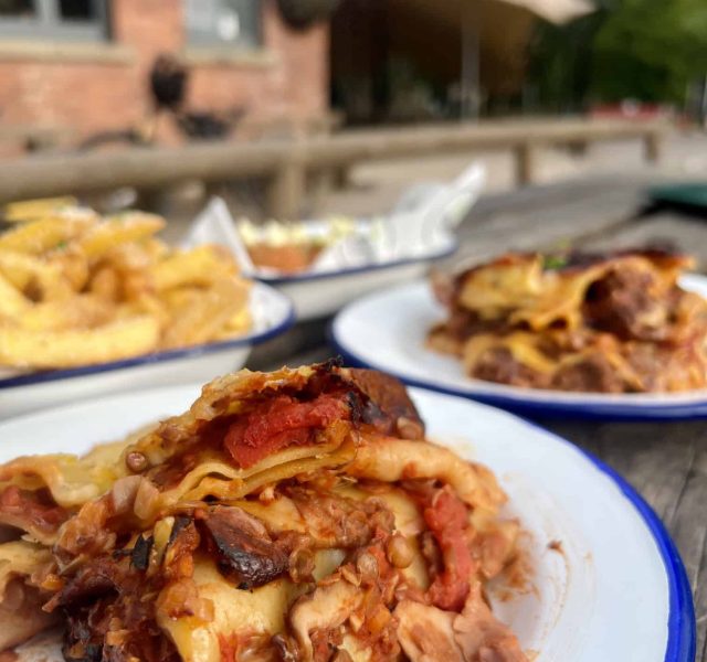 Our homemade vegetable lasagne, beef lasagne and seasoned fries, photo taken in front of our café