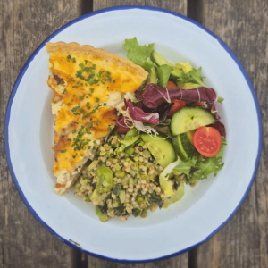 A plate of homemade quiche with salad
